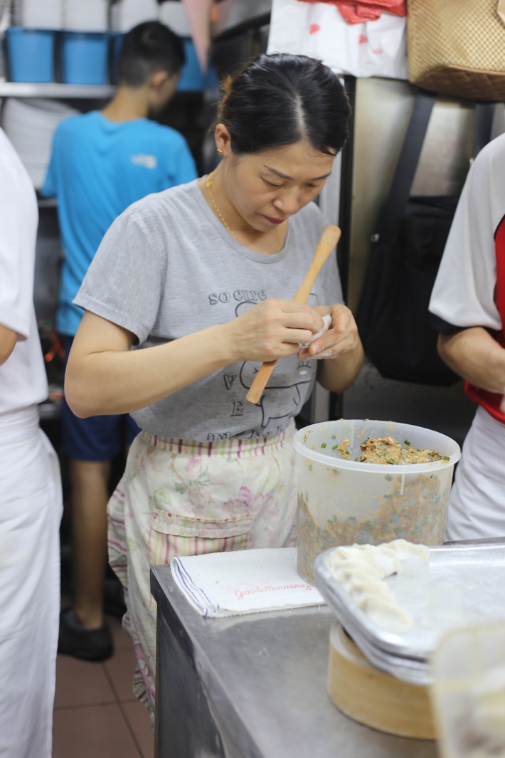 woman making dumplings zhong guo la mian xiao long bao